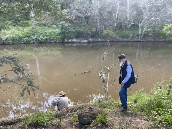 Uncle Dave and Uncle Andrew performing water exchange as part of Sydney Biennale, Collingwood Children's Farm 2023