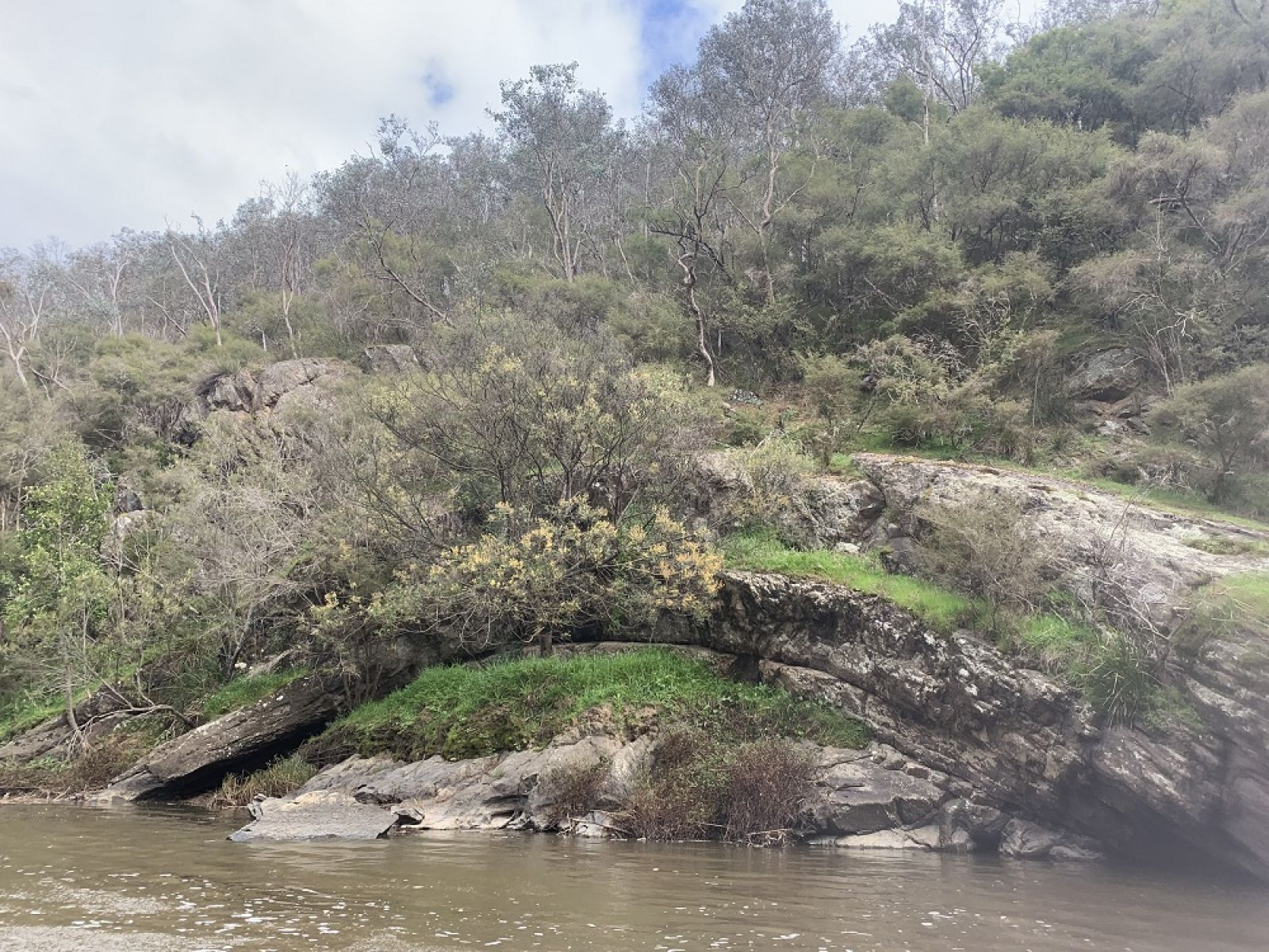 An arched rock formation next to the River